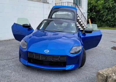A red sports car getting detailed at Total Detailing shop.