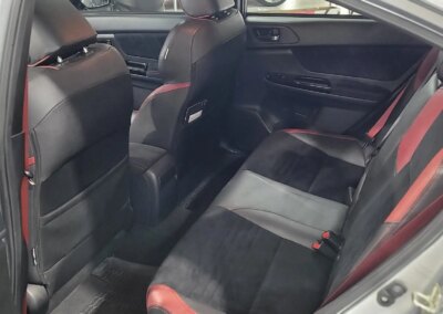 A car with a shiny, polished finish after professional detailing service.
