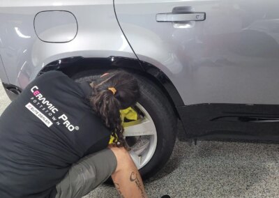 A shiny black car after detailing with a glossy finish.