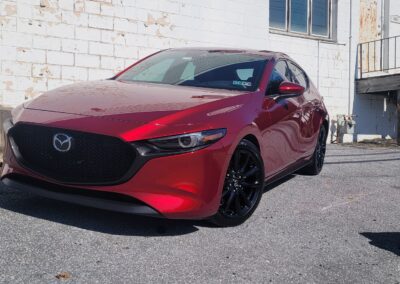 A car with a shiny, polished exterior after detailing service.