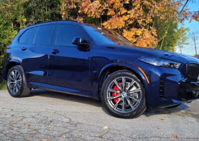 A clean and shiny black car after detailing service.