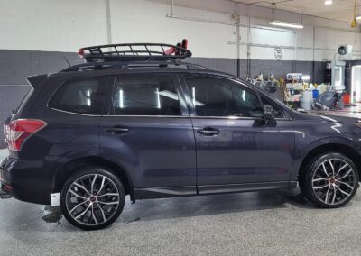 A black car with glossy finish after detailing service.